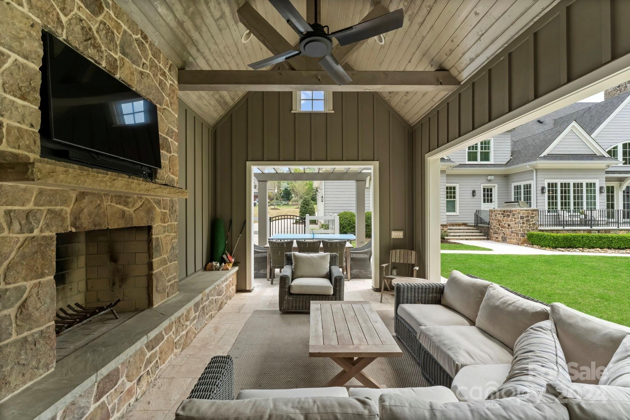 905 Martingale Lane Davidson, NC 28036 - Photo 6 of 45 a living room with furniture a flat screen tv and a fireplace