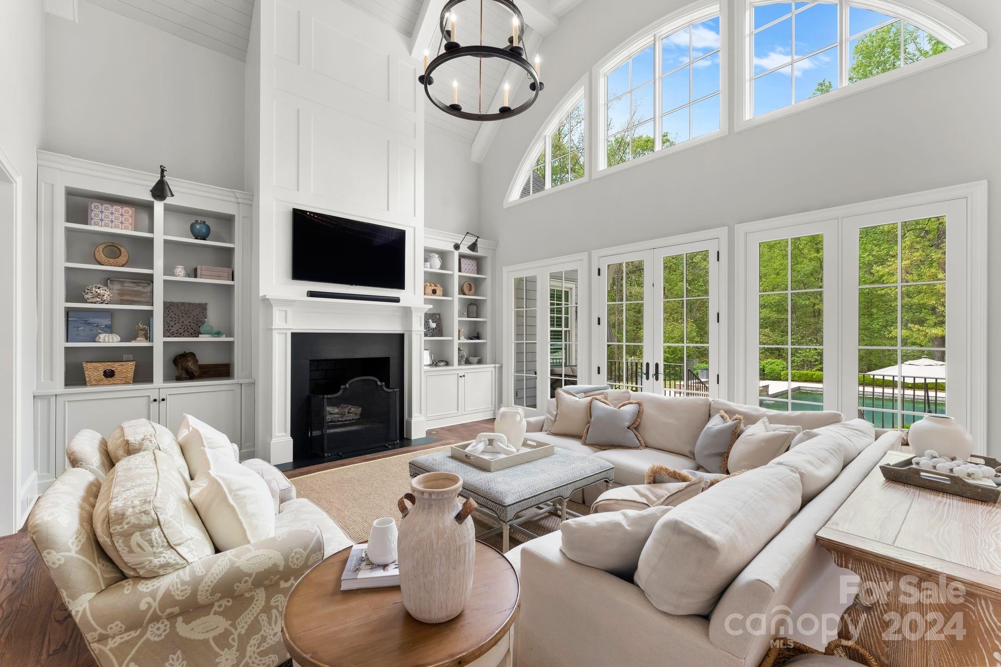 905 Martingale Lane Davidson, NC 28036 - Photo 10 of 45 a living room with furniture a fireplace and a flat screen tv