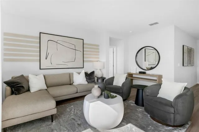 a living room with furniture a mirror and a window