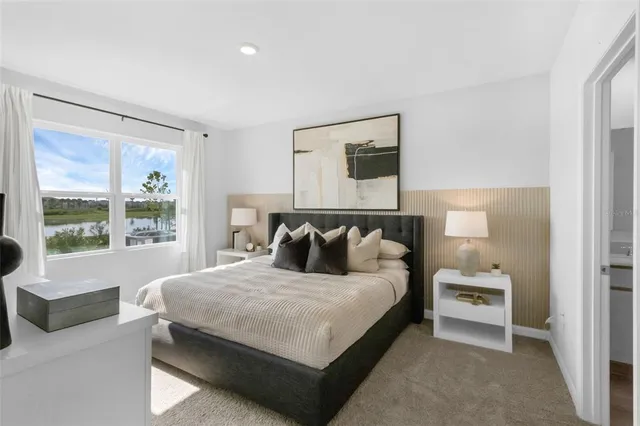 a bedroom with a large bed and a window