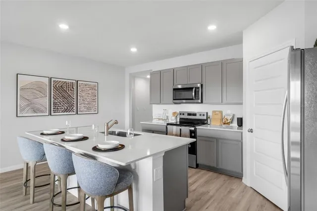 a kitchen with a sink stove and refrigerator