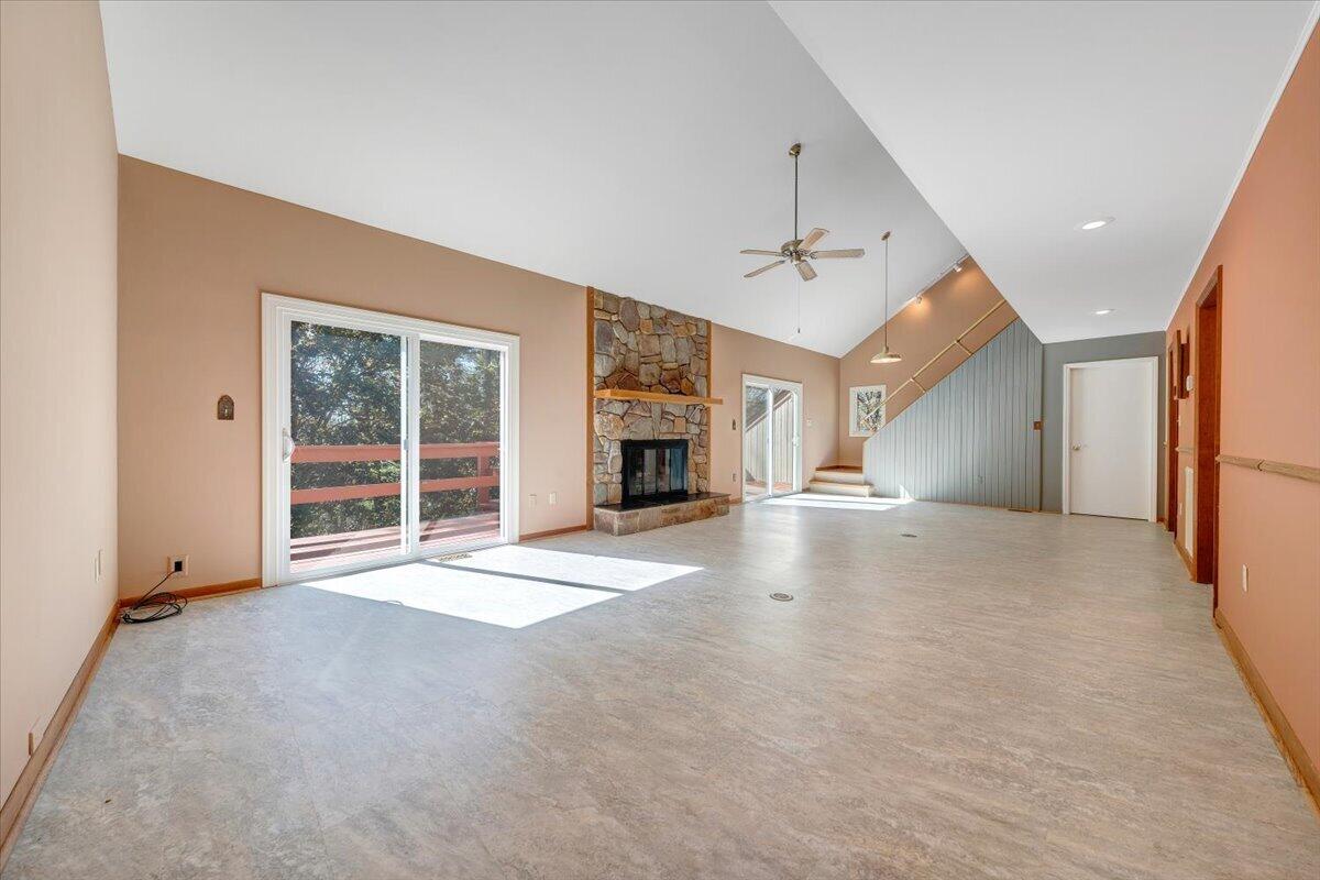 1465 Poff School Road Riner, VA 24149 - Photo 13 of 77 a view of an empty room with a fireplace and a window