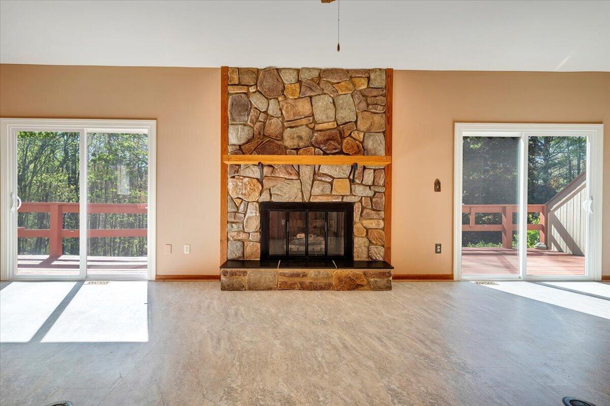 1465 Poff School Road Riner, VA 24149 - Photo 16 of 77 a view of an empty room with a fireplace and a window