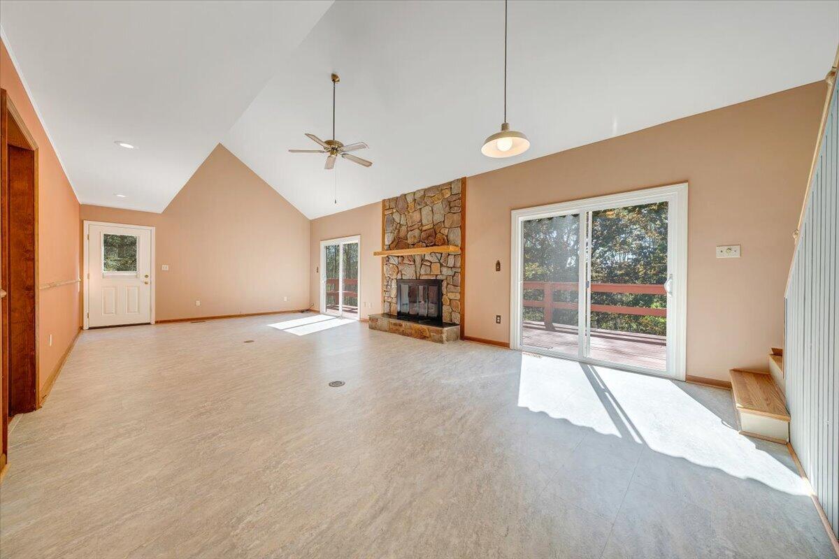 1465 Poff School Road Riner, VA 24149 - Photo 18 of 77 a view of empty room with fireplace and windows