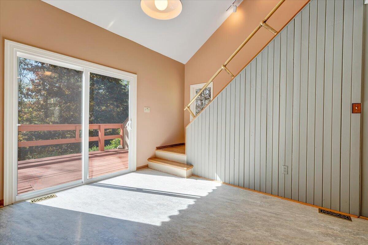 1465 Poff School Road Riner, VA 24149 - Photo 20 of 77 a view of a big room with wooden floor and windows