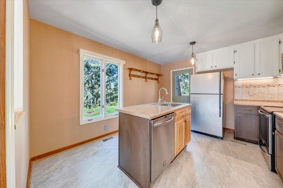 1465 Poff School Road Riner, VA 24149 - Photo 23 of 77 a kitchen with stainless steel appliances granite countertop a refrigerator a oven a stove and a refrigerator