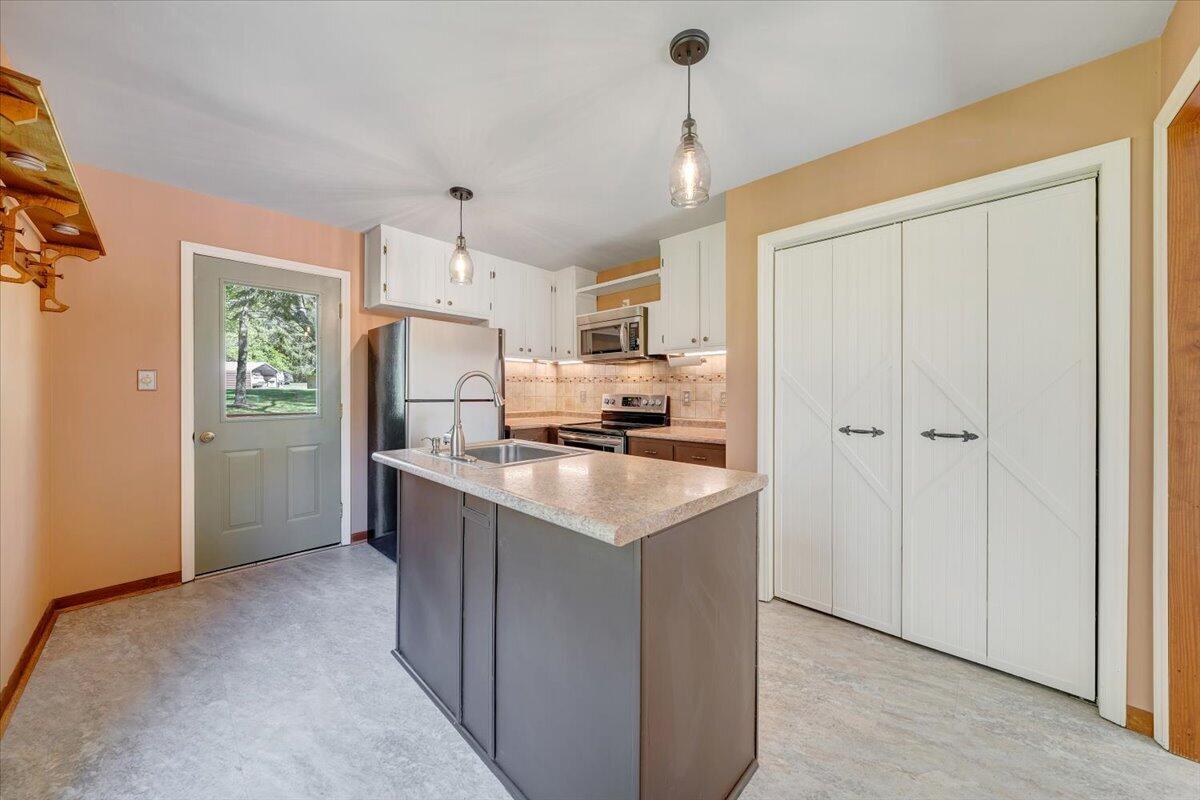 1465 Poff School Road Riner, VA 24149 - Photo 25 of 77 a kitchen with stainless steel appliances granite countertop a refrigerator a stove a sink and a refrigerator