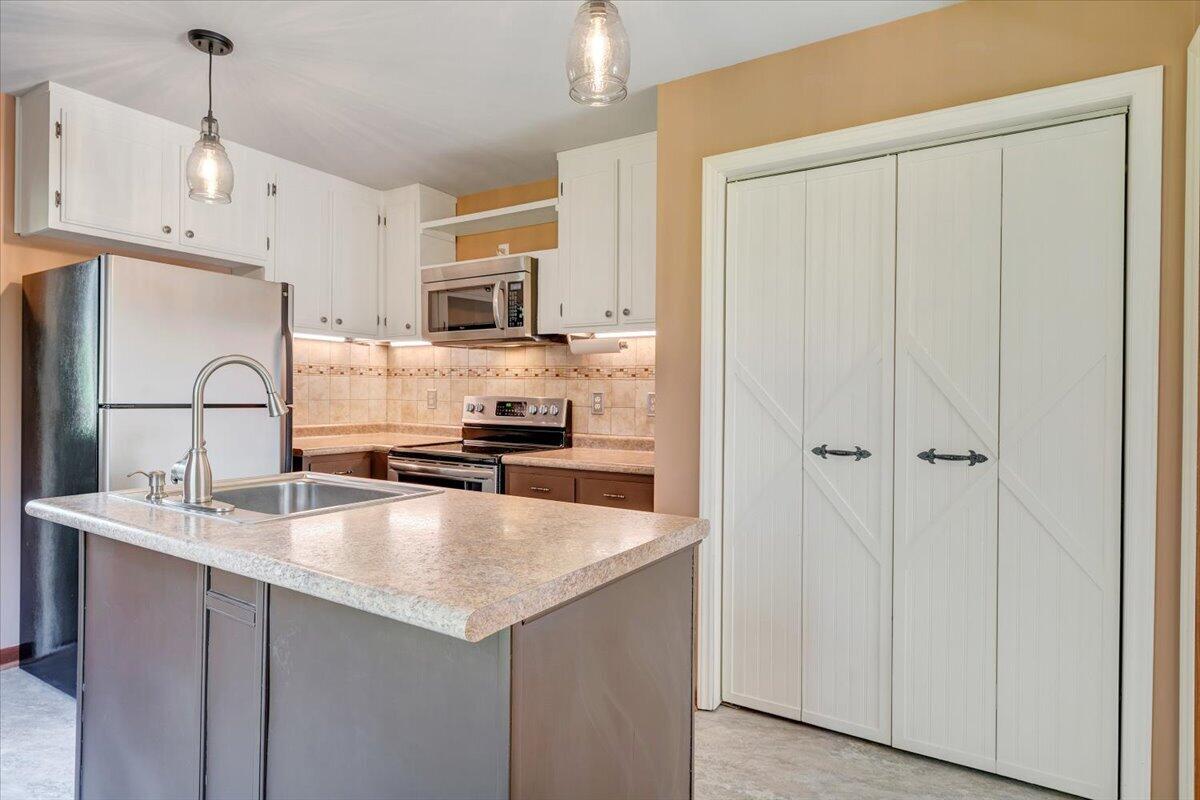 1465 Poff School Road Riner, VA 24149 - Photo 26 of 77 a kitchen with kitchen island a counter top space cabinets and stainless steel appliances
