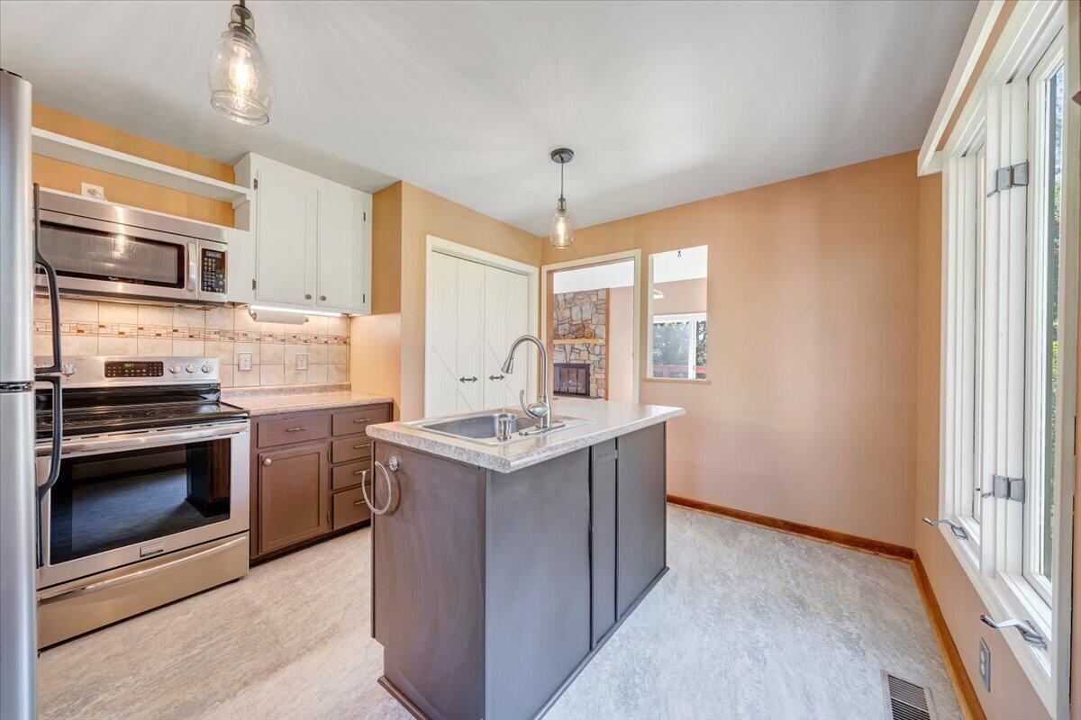 1465 Poff School Road Riner, VA 24149 - Photo 28 of 77 a kitchen with stainless steel appliances granite countertop a stove and a refrigerator