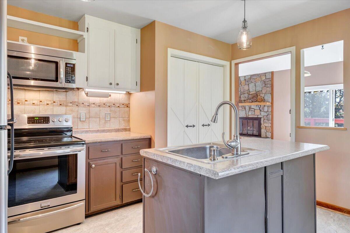 1465 Poff School Road Riner, VA 24149 - Photo 29 of 77 a kitchen with granite countertop a sink stainless steel appliances and cabinets