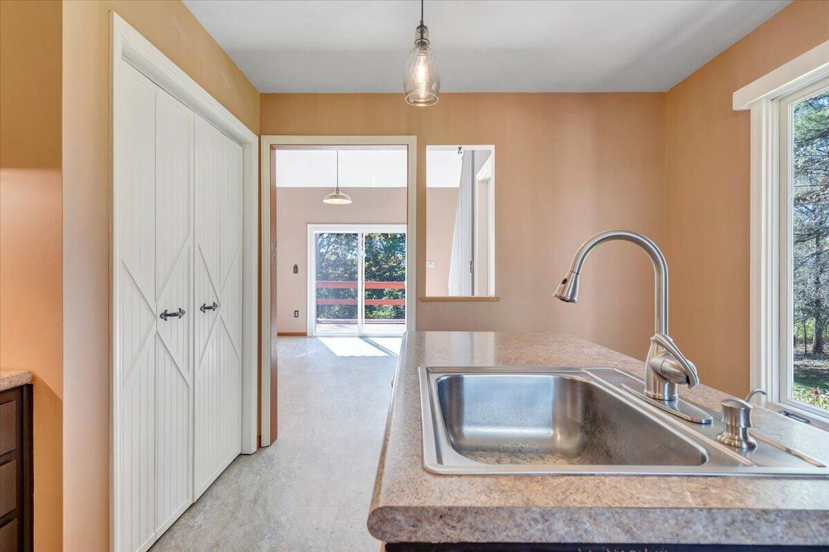 1465 Poff School Road Riner, VA 24149 - Photo 30 of 77 a kitchen with a granite countertop sink and natural light