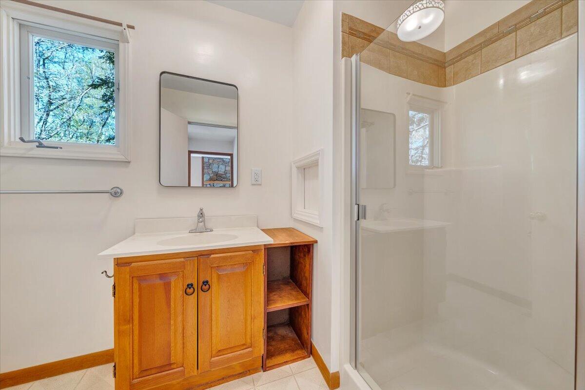 1465 Poff School Road Riner, VA 24149 - Photo 37 of 77 a bathroom with a sink a toilet and mirror