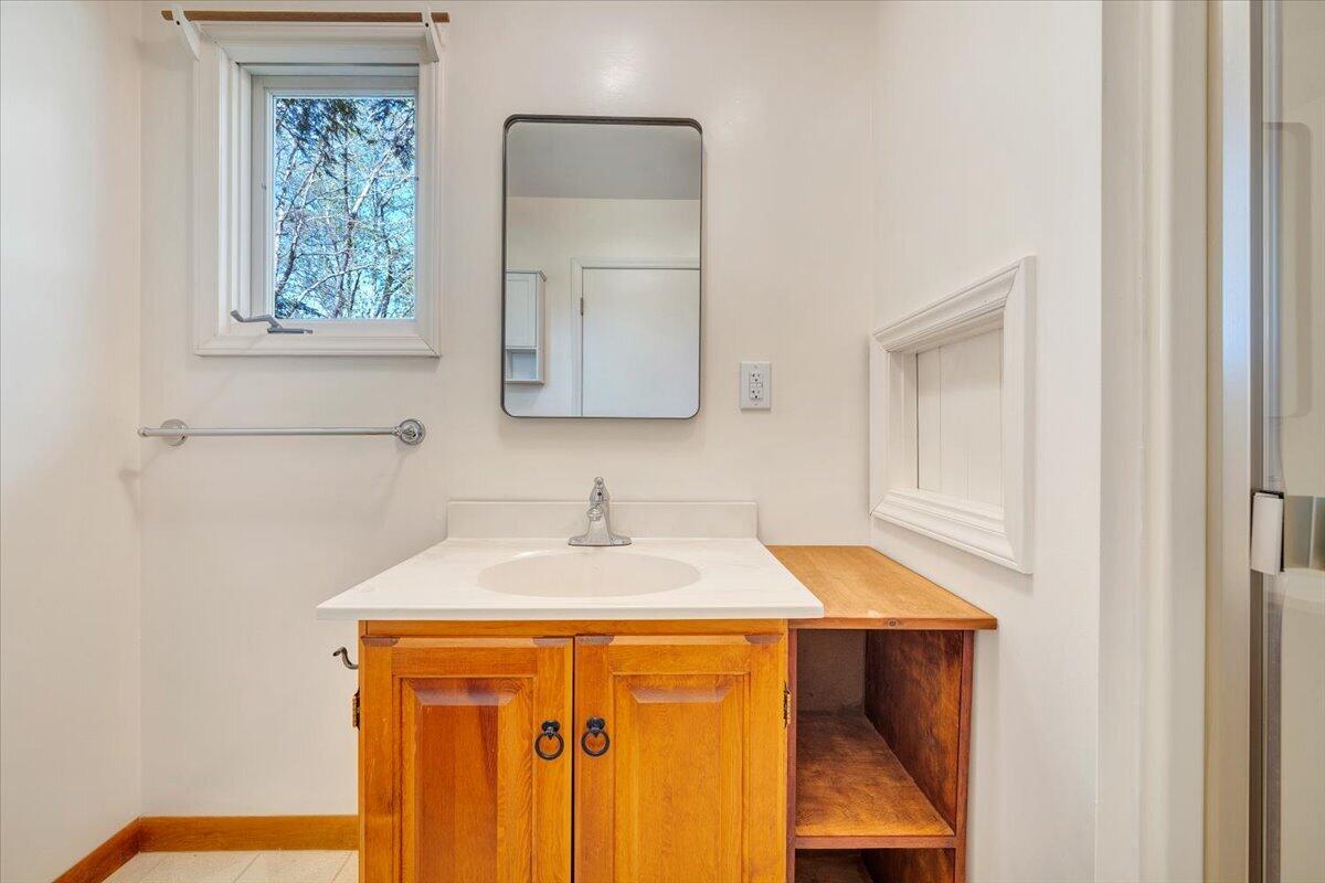 1465 Poff School Road Riner, VA 24149 - Photo 38 of 77 a bathroom with a sink a vanity and a mirror