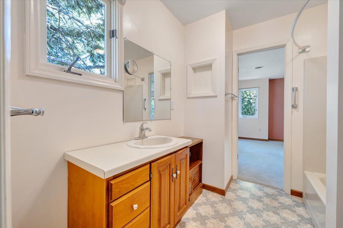 1465 Poff School Road Riner, VA 24149 - Photo 45 of 77 a bathroom with a sink a mirror and a window