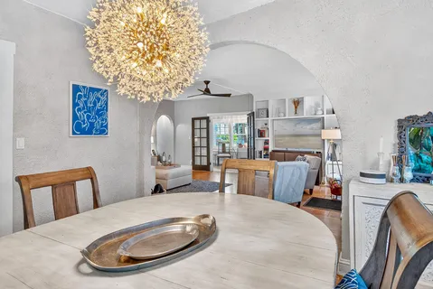 a kitchen with stainless steel appliances white cabinets a sink and a stove