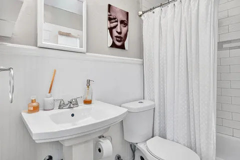 a bathroom with a toilet a sink and a bathtub