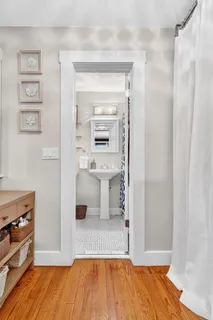 a bathroom with a sink toilet and window