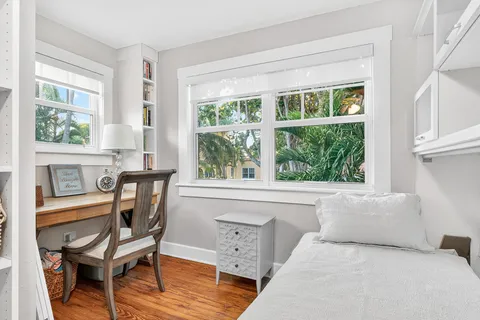 a bedroom with furniture and wooden floor