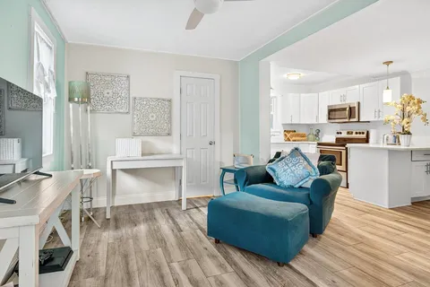 a kitchen with stainless steel appliances white cabinets and a sink