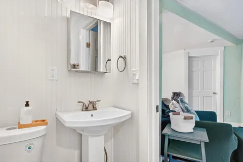 a view of a patio with table and chairs potted plants and a large tree