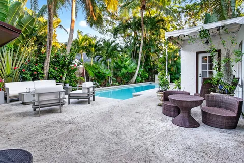 a view of a patio with furniture and garden