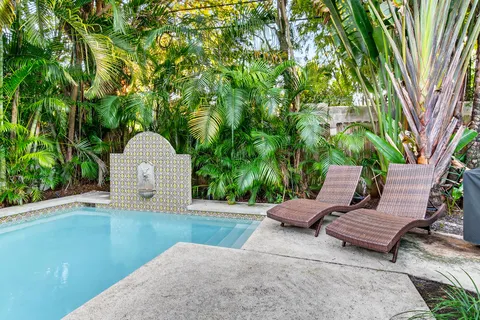 a view of a yard in front of a house with a tree