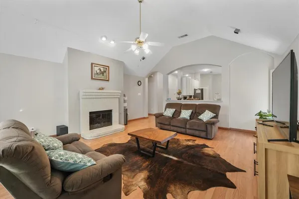 a living room with furniture fireplace and a chandelier