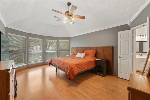a bed sitting in a bedroom next to a window
