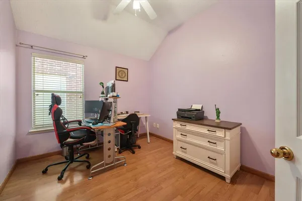 a view of a workspace with furniture and a window