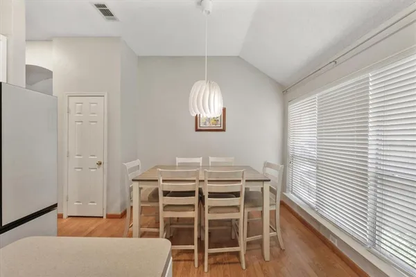 a dining room with furniture and window