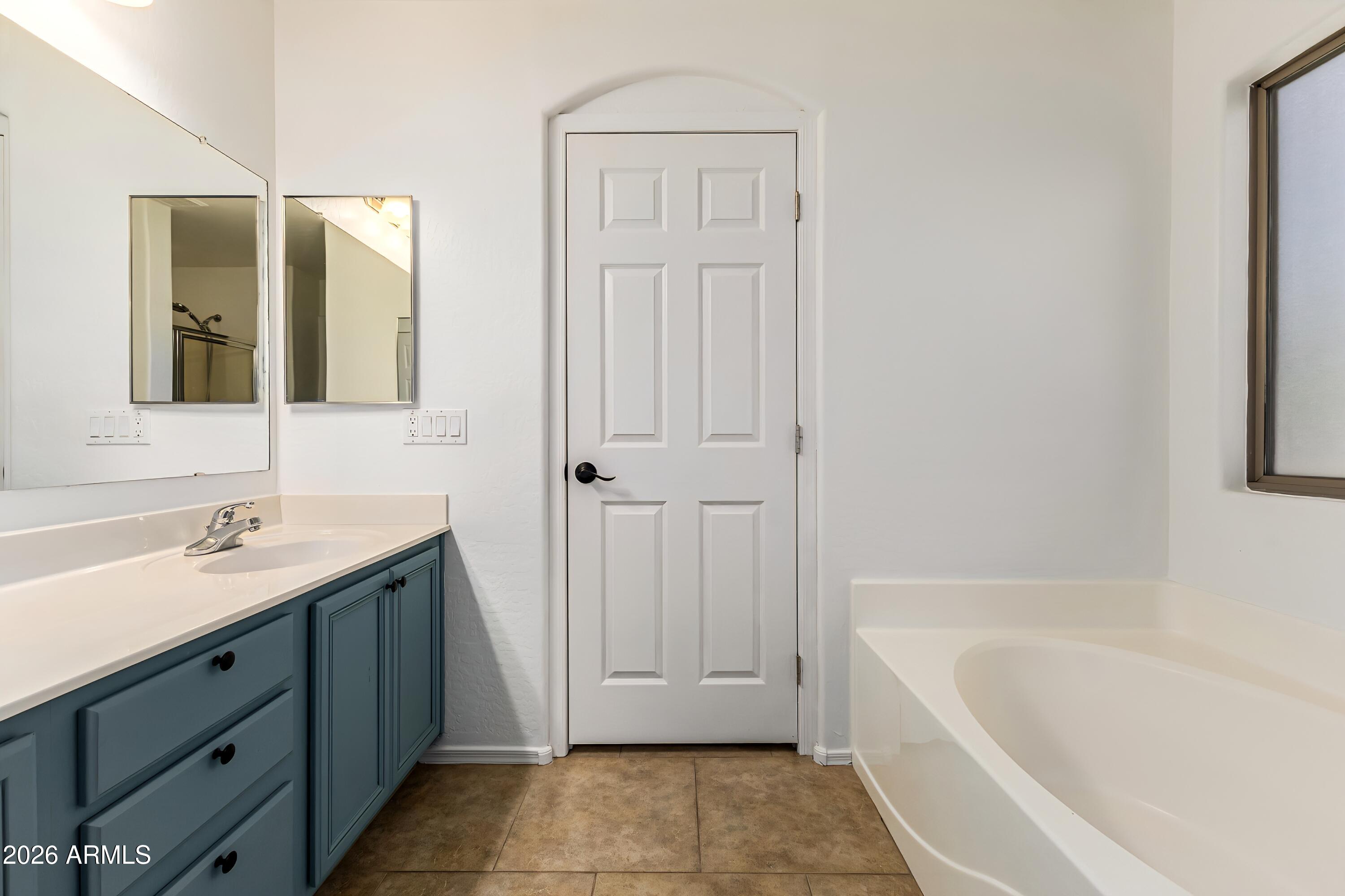 4208 South Sawmill Road Gilbert, AZ 85297 - Photo 22 of 46 a bathroom with a tub sink and mirror
