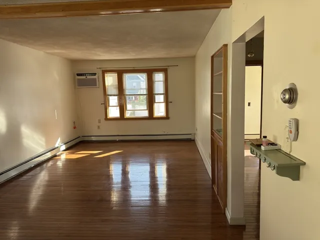 a view of a room with wooden floor