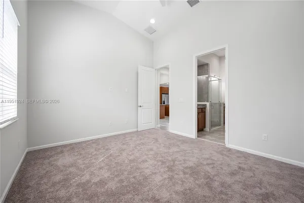 an empty room with closet and a window
