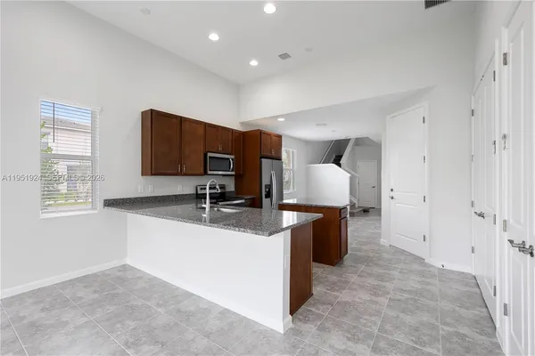 a large room with a couch and a stove top oven