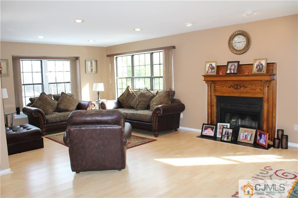 4901 Stonehedge Road, Unit 4901 Edison, NJ 08820 - Photo 2 of 22 a living room with furniture and a fireplace
