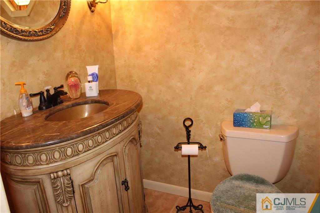 4901 Stonehedge Road, Unit 4901 Edison, NJ 08820 - Photo 12 of 22 a bathroom with a sink and a mirror