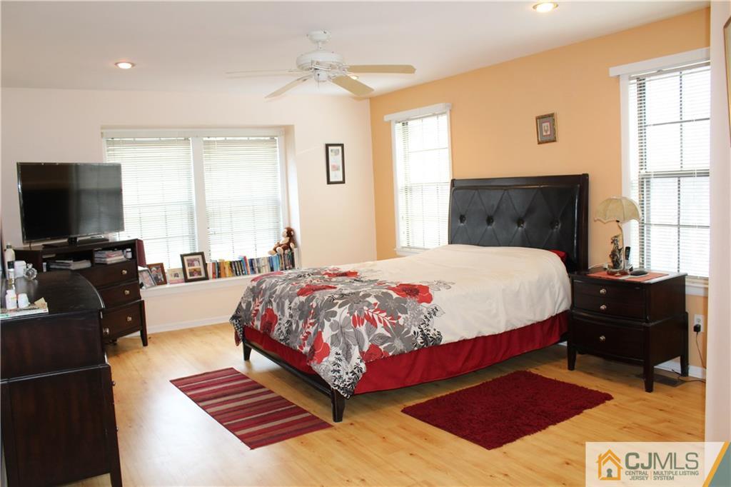 4901 Stonehedge Road, Unit 4901 Edison, NJ 08820 - Photo 14 of 22 a bedroom with a bed and a flat screen tv