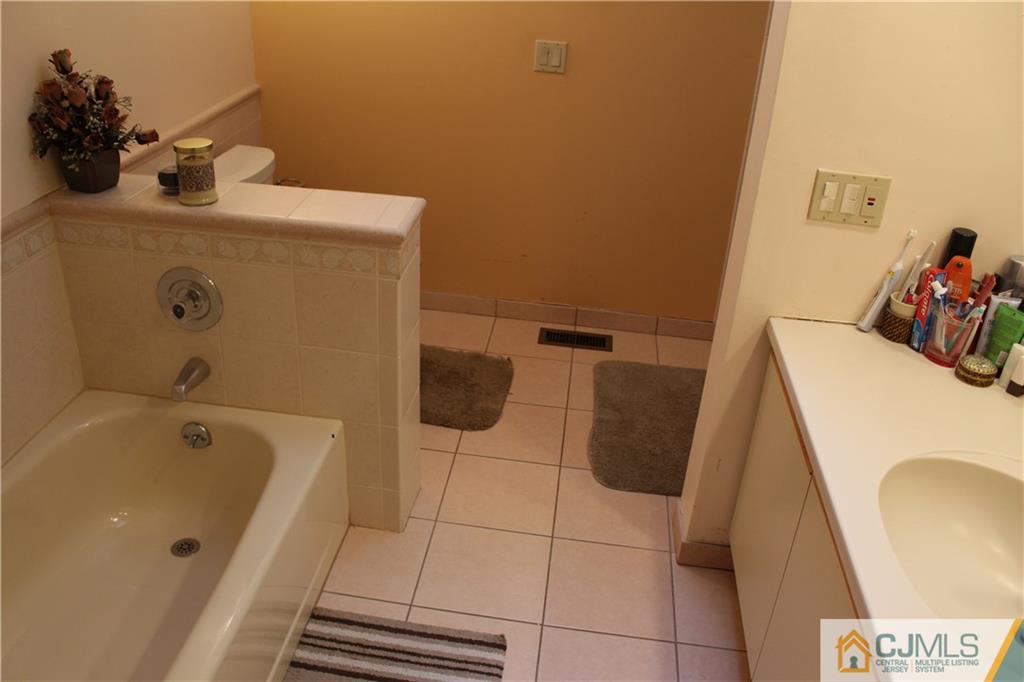 4901 Stonehedge Road, Unit 4901 Edison, NJ 08820 - Photo 15 of 22 a bathroom with a tub and sink