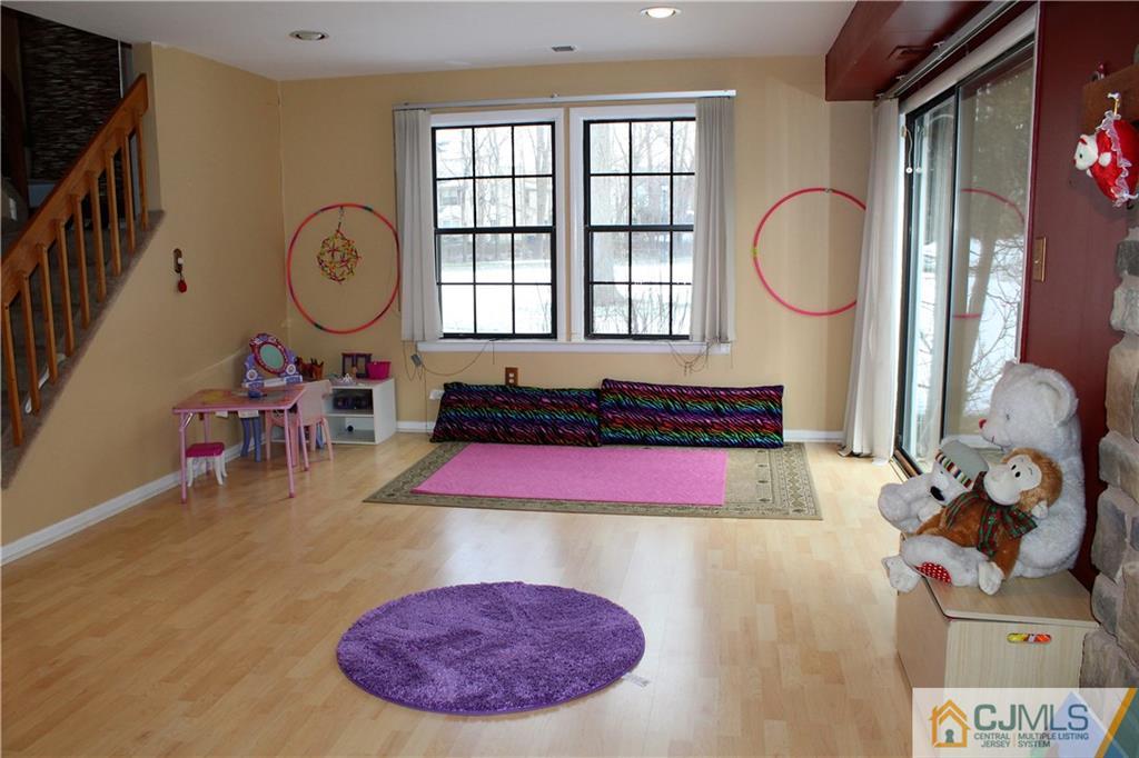 4901 Stonehedge Road, Unit 4901 Edison, NJ 08820 - Photo 19 of 22 a living room with furniture a rug toys and a window
