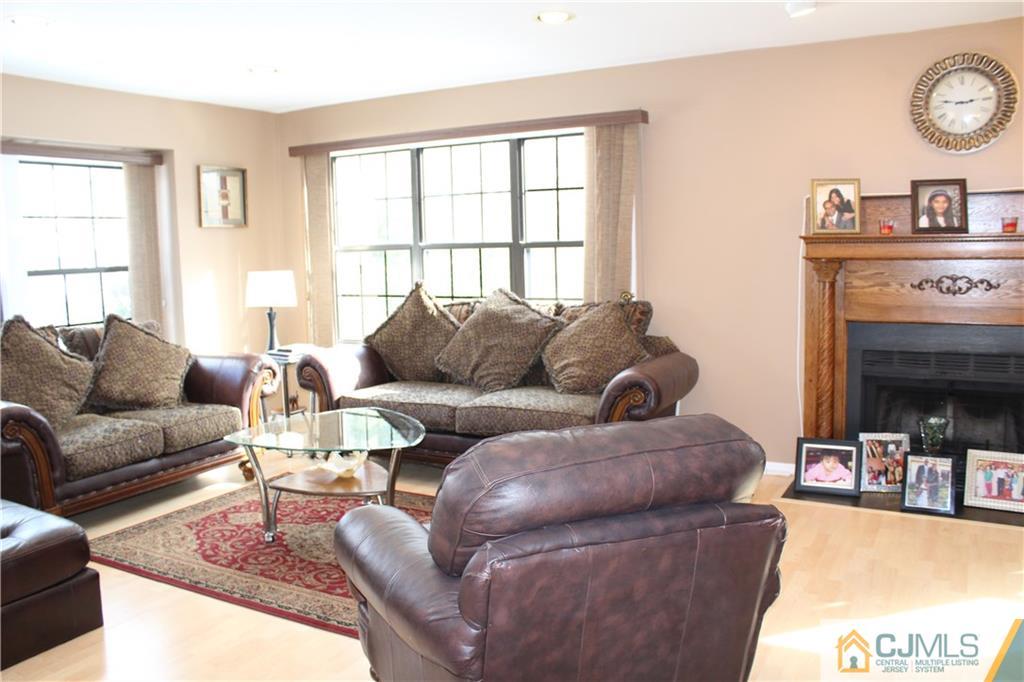 4901 Stonehedge Road, Unit 4901 Edison, NJ 08820 - Photo 3 of 22 a living room with furniture and a fireplace