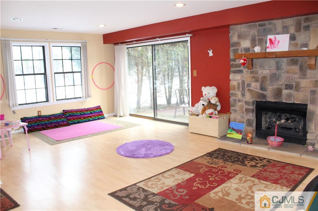 4901 Stonehedge Road, Unit 4901 Edison, NJ 08820 - Photo 21 of 22 a living room with furniture and a fireplace