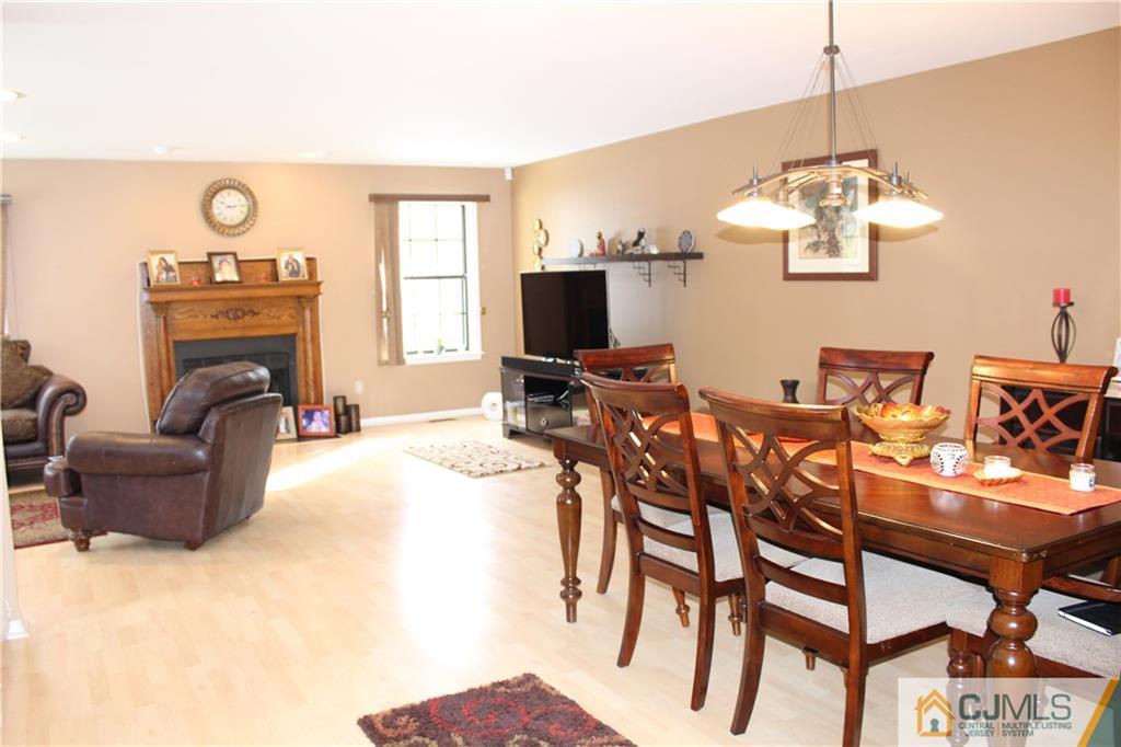4901 Stonehedge Road, Unit 4901 Edison, NJ 08820 - Photo 4 of 22 a living room with furniture a fireplace and a chandelier