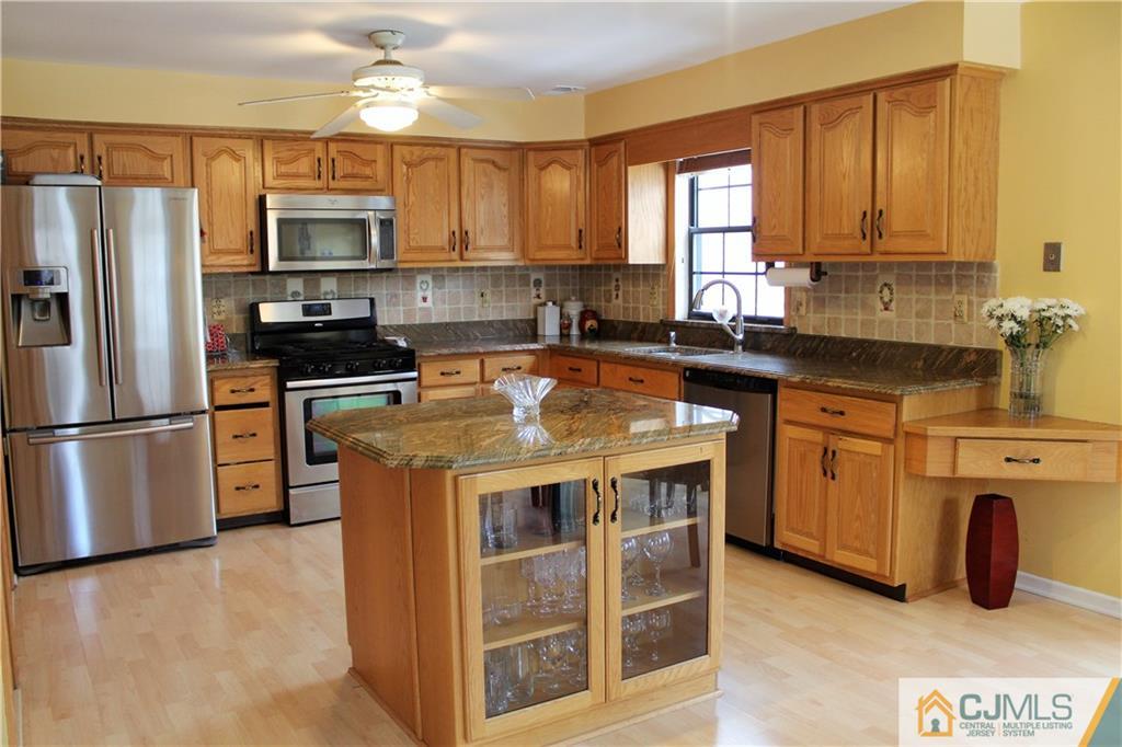 4901 Stonehedge Road, Unit 4901 Edison, NJ 08820 - Photo 7 of 22 a kitchen with stainless steel appliances granite countertop a stove a sink dishwasher a refrigerator and a microwave oven