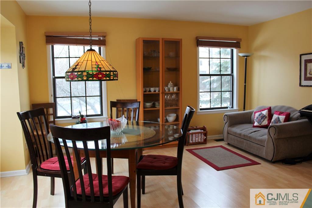 4901 Stonehedge Road, Unit 4901 Edison, NJ 08820 - Photo 10 of 22 a living room with furniture a window and a chandelier
