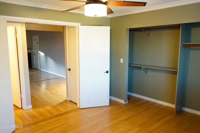 a view of empty room with wooden floor