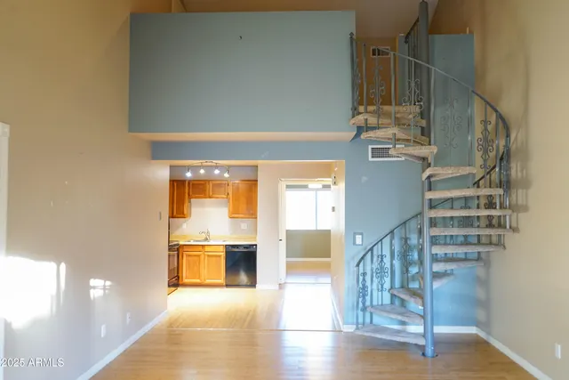 a view of entryway and hall with wooden floor