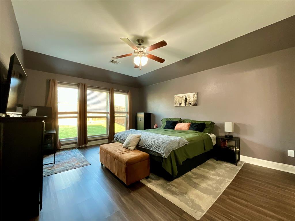 4005 Wavertree Road Frisco, TX 75036 - Photo 7 of 14 Hardwood-look flooring, multiple windows, ceiling fan, and tray ceiling