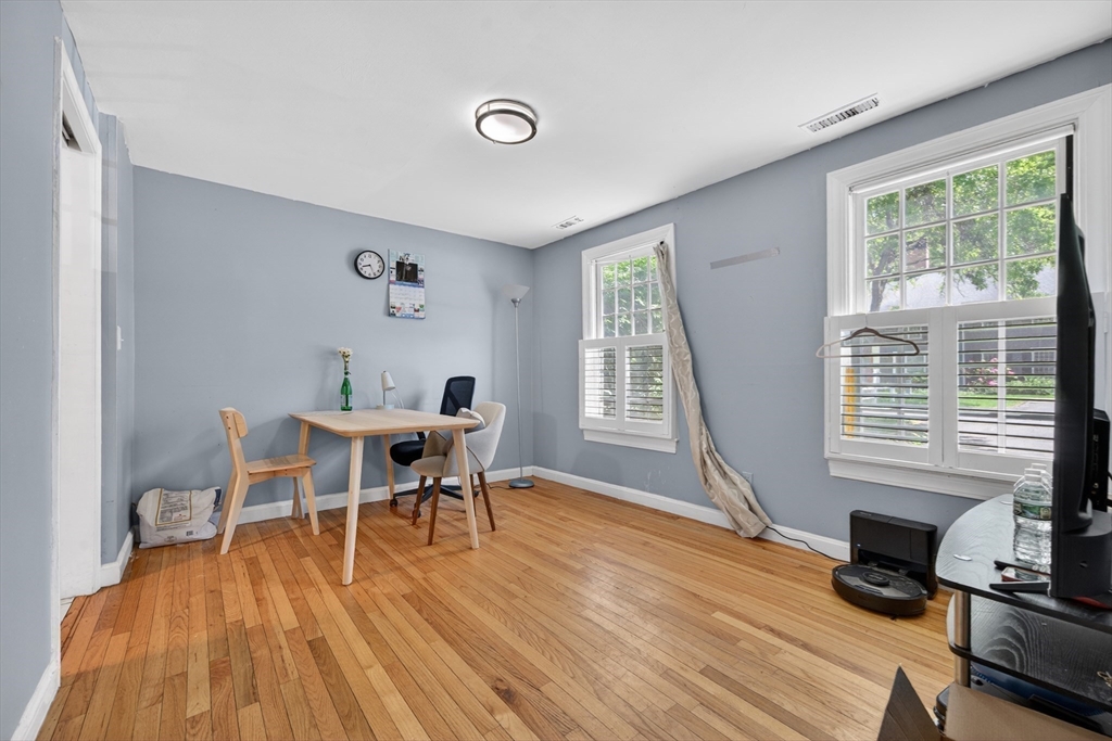 68 Jericho Road, Unit 68 Weston, MA 02493 - Photo 11 of 25 a dining room with wooden floor and a window