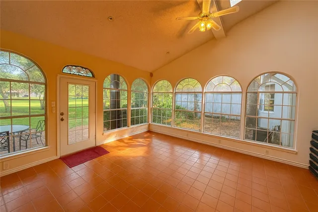 a view of an empty room with a floor to ceiling window and an empty room