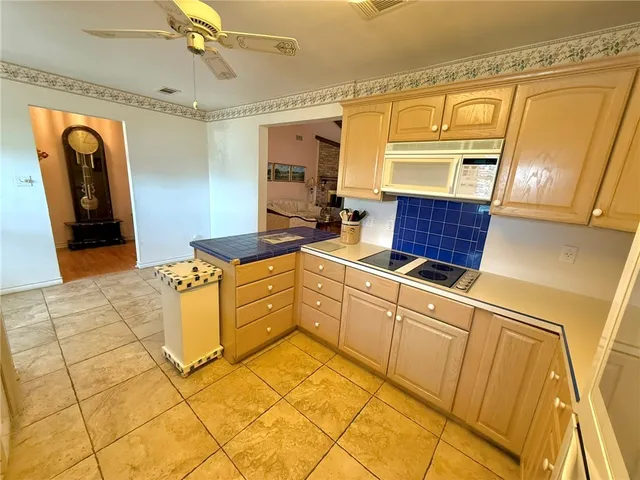 a kitchen with cabinets and wooden floor